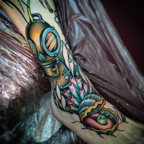 Vibrant underwater leg tattoo featuring a vintage diver helmet, coral reef, and an open clam with a glowing green pearl.