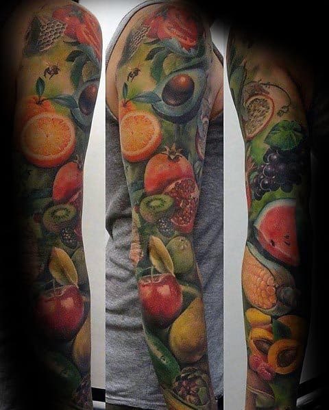 Vibrant full-sleeve tattoo featuring a detailed assortment of fruits, including oranges, apples, kiwis, and watermelon, in a realistic style.
