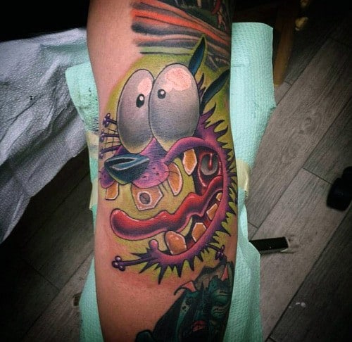Vibrant Courage the Cowardly Dog tattoo with exaggerated features and a ripped-skin effect, surrounded by intense colors and shading.