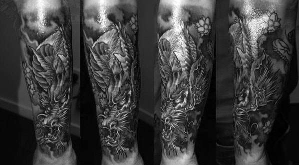 Black and white dragon tattoo on forearm