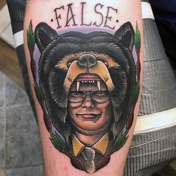 Tattoo of Dwight Schrute wearing a fierce bear headdress, framed by beets and leaves, with "FALSE" written above in bold letters.