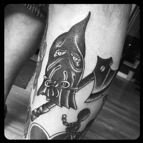 Black and grey executioner tattoo featuring a hooded face with tired eyes, a tied cloth mask, and a detailed axe with bold shading.