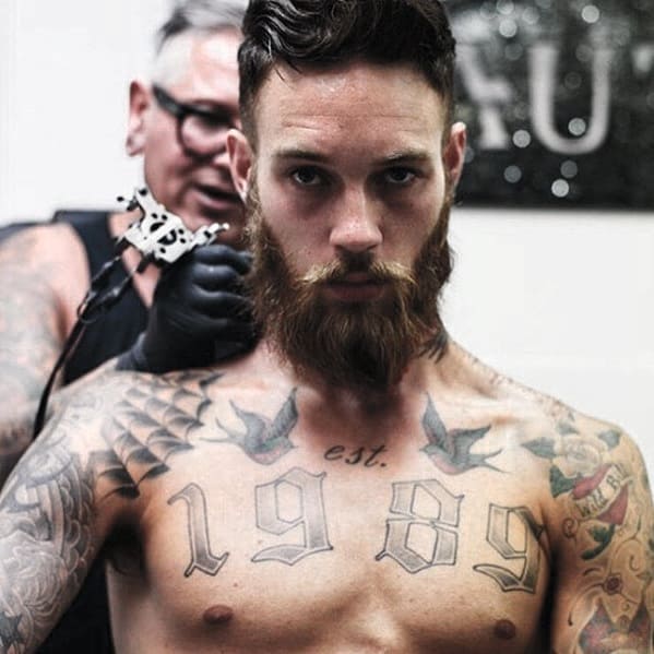 Man with Beard and Undercut getting tattooed