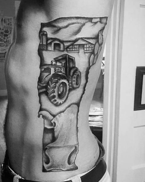 Black and gray side tattoo of a tractor labeled "802" driving through a rural scene, framed in the shape of Vermont.