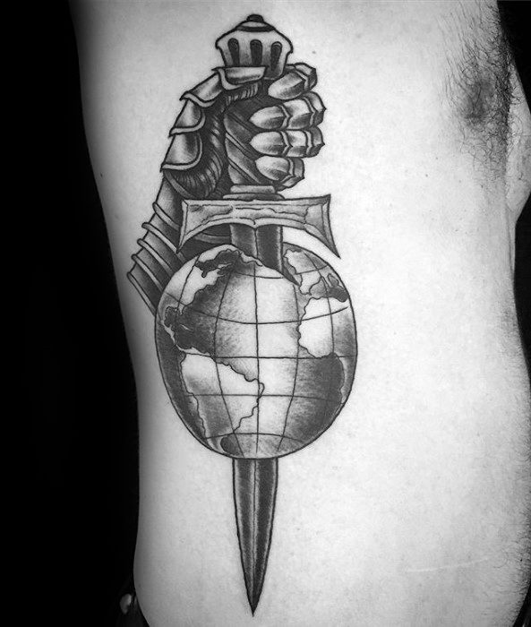 Black and grey tattoo of a knight's gauntlet gripping a sword that pierces through a globe, symbolizing power and global dominance.