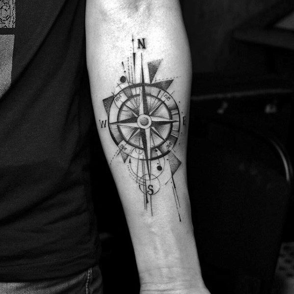 Forearm compass tattoo with bold shading, geometric fragments, and fine line detailing, merging classic navigation with modern art.
