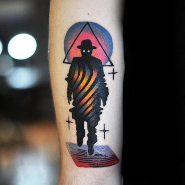 Surreal gradient tattoo of a silhouetted figure with swirling orange and blue light, set against a triangle and circular sunset backdrop.
