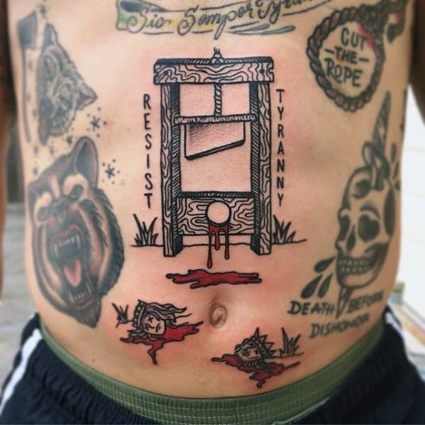 Bold guillotine tattoo on the torso with “RESIST TYRANNY” text, decapitated heads, blood pools, and strong woodgrain detail throughout.