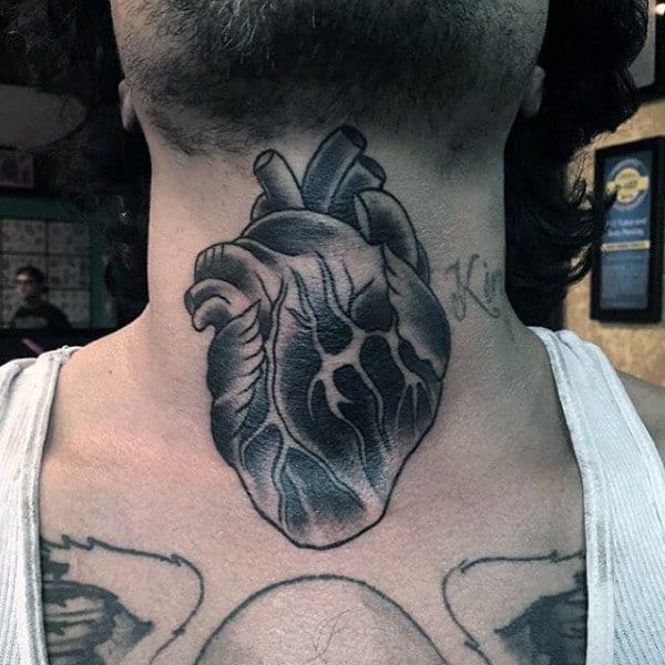 Throat tattoo featuring a realistic black and gray anatomical heart with intricate shading and bold details for a striking design