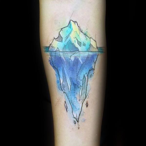 Vibrant watercolor-style iceberg tattoo with soft blue and yellow hues, showing the vast submerged portion beneath the waterline.