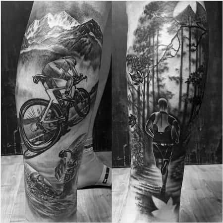 Detailed black and grey tattoo showcasing the Ironman race: cycling through mountains, swimming in water, and running through a forest, highlighting the endurance required for each stage.