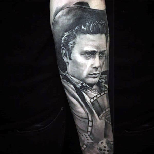 Black and grey tattoo of James Dean in a cowboy hat with film reel and dice details, capturing a cinematic Western vibe.