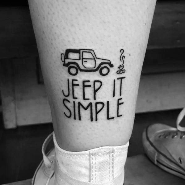 Minimalist black ink tattoo featuring a simple Jeep outline, a small campfire, and the phrase "JEEP IT SIMPLE" in bold uppercase letters.