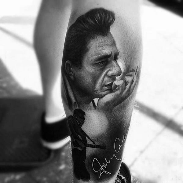Leg tattoo featuring Johnny Cash's portrait, a guitarist silhouette, and a signature