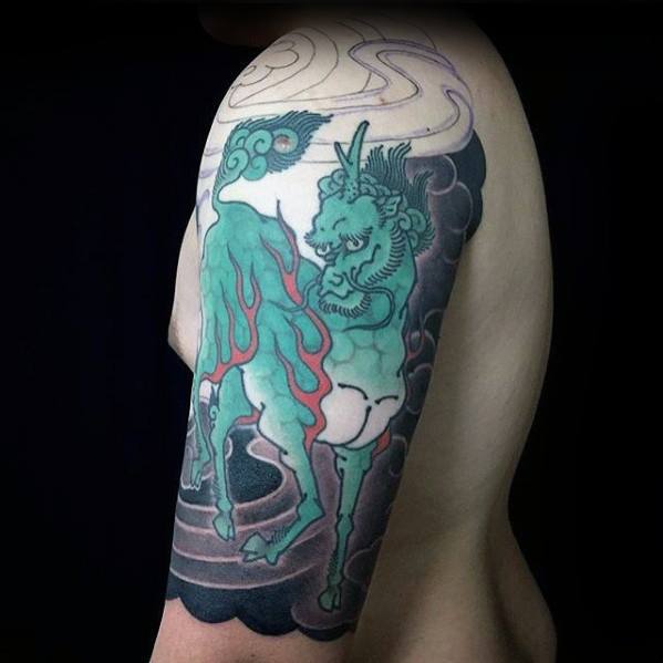 Minimalist-style Kirin tattoo on the upper arm with teal tones, red flames, and bold black cloud patterns in a clean Japanese design.