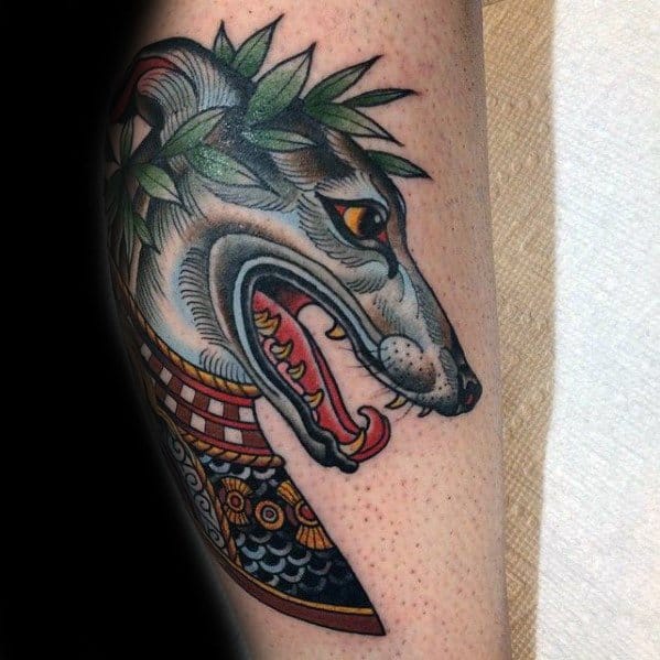 A vibrant and detailed tattoo of a greyhound’s head, adorned with a laurel wreath and traditional Japanese-inspired elements, featuring bold lines and striking colors.