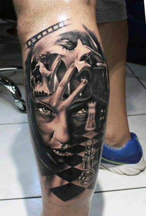 Leg tattoo featuring a woman's face, skulls, chess pieces, and film strip elements