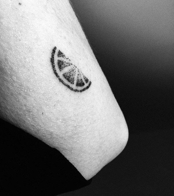 Tiny dotwork tattoo of a lemon wedge on the arm, featuring simple black shading and a minimalistic design.