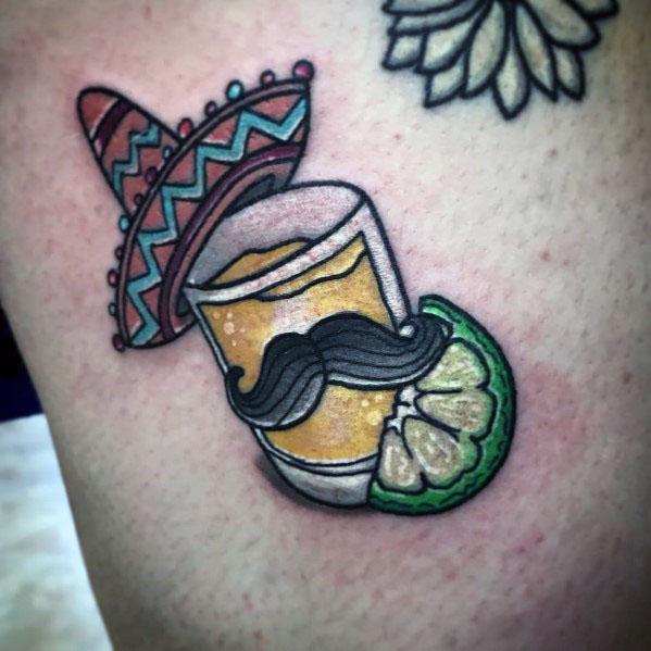 Fun tequila shot tattoo featuring a sombrero, mustache, and lime wedge, creating a playful and festive Mexican-inspired design.