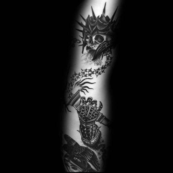 Dark and detailed mace tattoo featuring a spiked ball with a skull, a barbed chain, and an armored hand, symbolizing power, death, and battle.