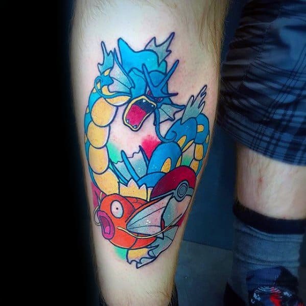 Bright Magikarp and Gyarados tattoo with a Poké Ball centerpiece, bold outlines, and striking contrast between orange and blue tones.