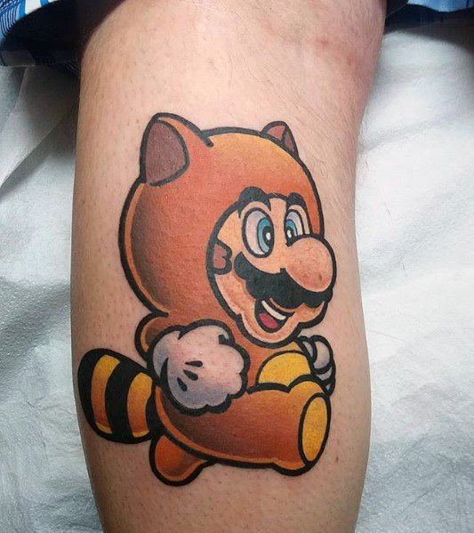 Bright and bold *Super Mario* tattoo featuring Mario in his classic Tanooki suit, with clean lines and vibrant colors for a nostalgic gaming look.