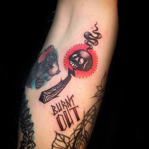 Bold neo-traditional tattoo of a burnt match with a skull and smoke, paired with "Burnt Out" text, symbolizing exhaustion or inner struggle.