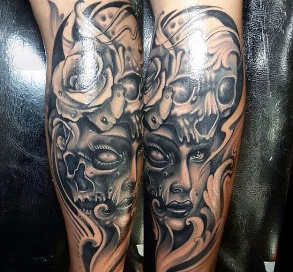Dark and detailed calf tattoo featuring a woman's face merging with a skull, adorned with roses and intricate shading for a dramatic effect