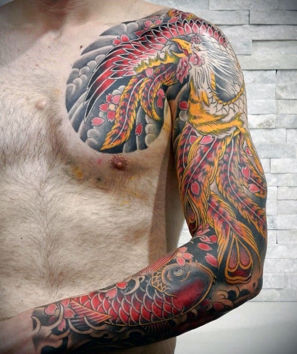 Japanese-style full sleeve and chest tattoo featuring a majestic phoenix with fiery feathers, a koi fish, cherry blossoms, and swirling clouds