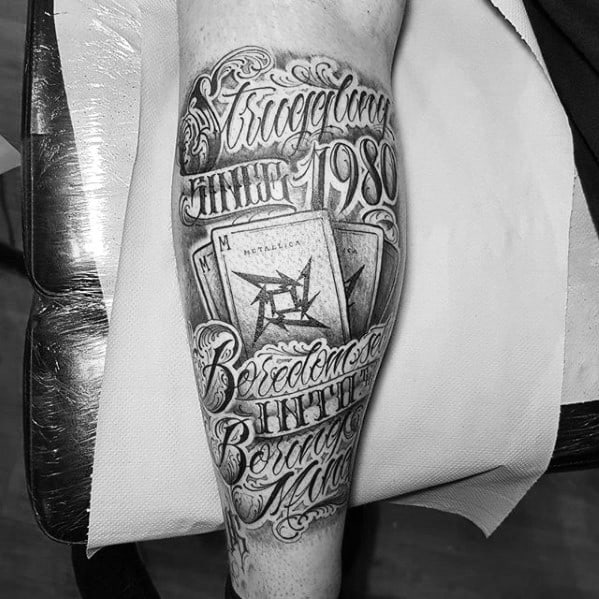 Intricate black and grey tattoo featuring ornate lettering, Metallica ninja star logo, and references to the year 1980, styled like vintage posters.