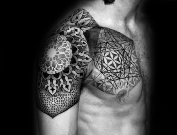 Chest and shoulder tattoo featuring Metatron’s Cube, Flower of Life, and mandala elements with detailed shading and geometric symmetry.