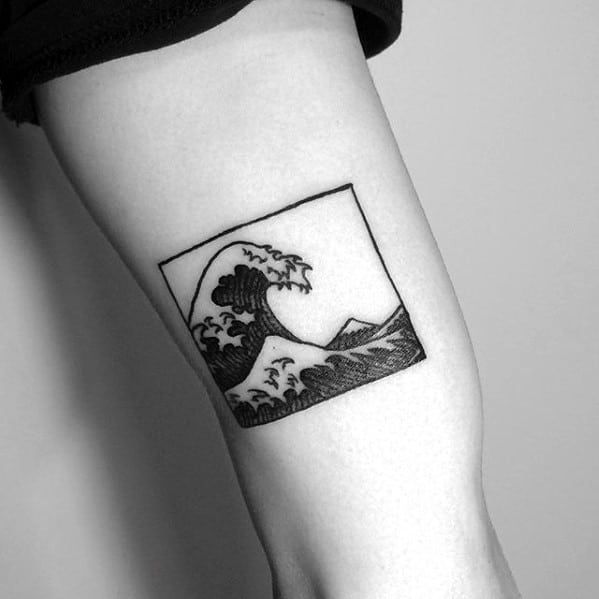 Minimalist black ink tattoo featuring a framed crashing wave with a distant mountain, inspired by Japanese art for a bold yet simple design.