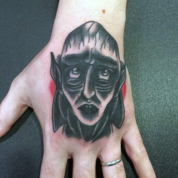 Manly Old School Black And Red Vampire Tattoo On Mans Hand