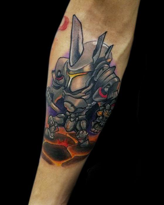 Colorful chibi-style tattoo of Reinhardt from Overwatch in his armor, standing on cracked ground with glowing lava effects.