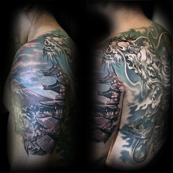 Shoulder and upper arm tattoo featuring a Japanese pagoda with a large white dragon, stormy skies, and Mount Fuji in the background.