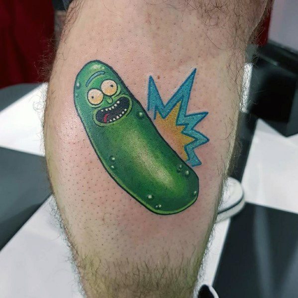 Simple and vibrant Pickle Rick tattoo with bold colors, a cartoonish expression, and a dynamic comic-style explosion on the calf.