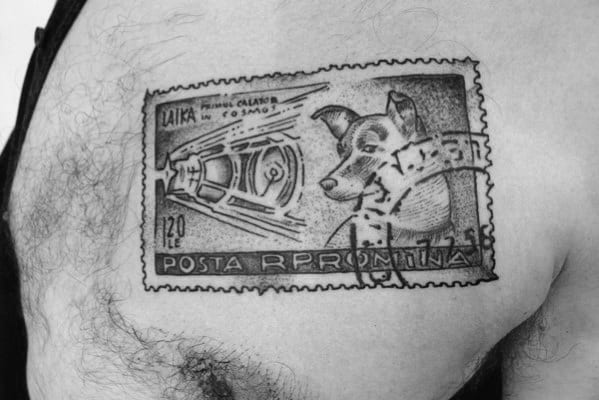 A tattoo of a vintage postage stamp featuring an enchanting space-themed design with an imaginative portrayal of a dog