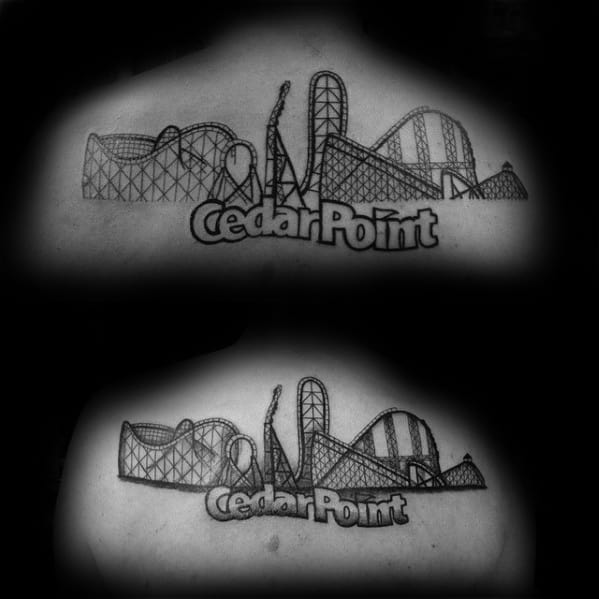 Black ink tattoo of Cedar Point skyline featuring detailed roller coasters and bold Cedar Point lettering across the upper back.