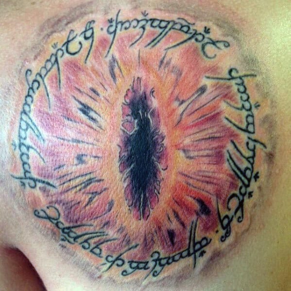 A mesmerizing tattoo featuring the Eye of Sauron, intricately encircled by elegant Elvish script