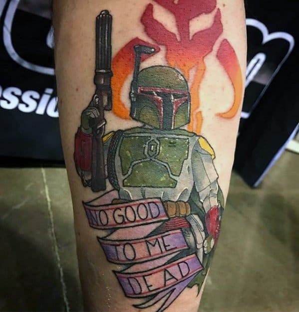 Colorful tattoo of Boba Fett holding his blaster with a flaming Mythosaur skull behind him and a banner reading “No good to me dead.”