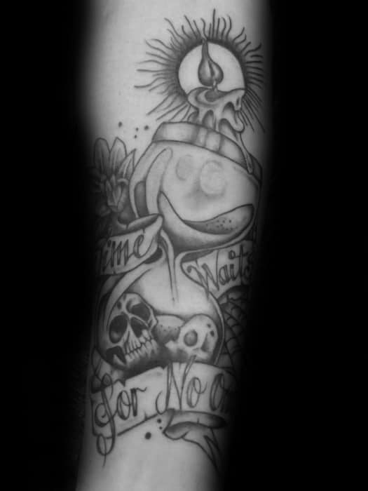 Black and grey tattoo with an hourglass, skulls, melting candle, and scroll text that reads Time Waits for No One.
