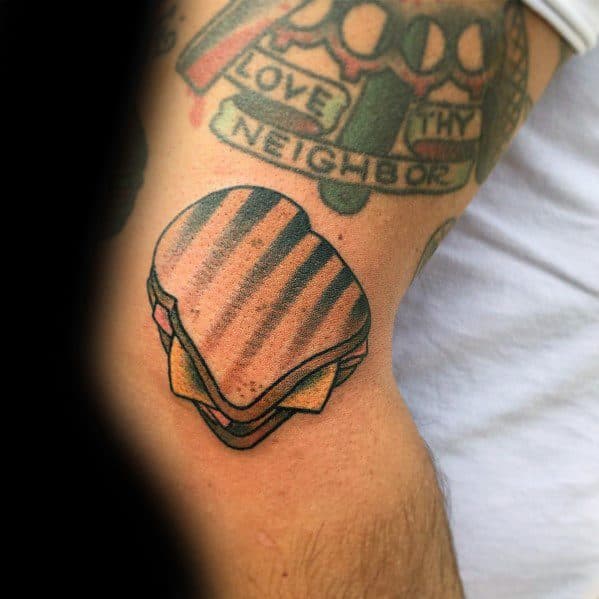 Grilled sandwich tattoo with bold shading and grill marks, featuring a classic design that highlights a love for toasted sandwiches.