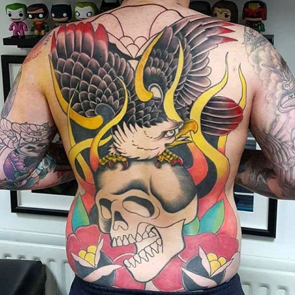 Man with a large back tattoo featuring an eagle and a skull with flames