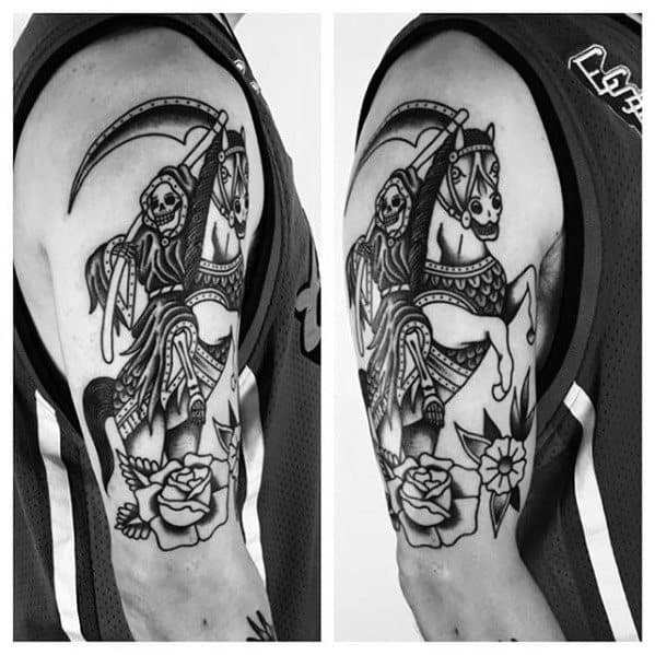 Black and grey upper arm tattoo of a skeleton reaper riding a horse with a scythe, detailed armor, and roses below the hooves.