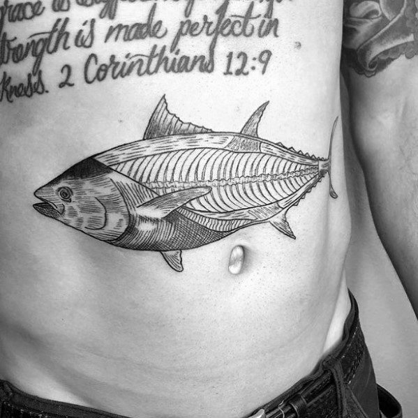 Detailed black and grey tuna fish anatomy tattoo on a man's stomach, featuring fine linework and shading for a realistic skeletal design.