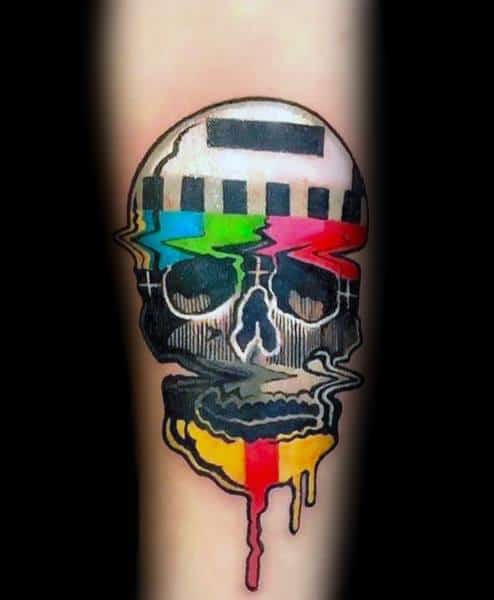 Tattoo of a distorted skull with a glitchy TV test pattern overlay, featuring vibrant colors dripping down, blending digital and surreal aesthetics.