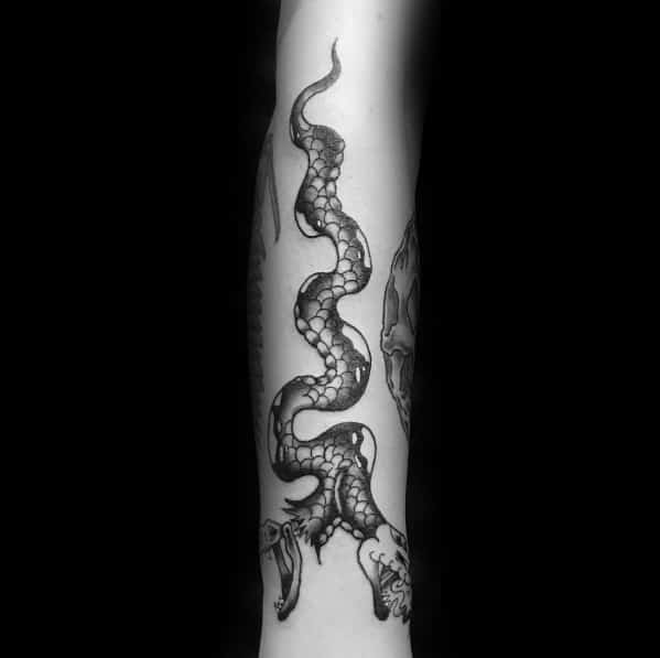 Black and grey two-headed snake tattoo on the forearm, featuring sharp fangs and detailed scales for a fierce and dynamic look.