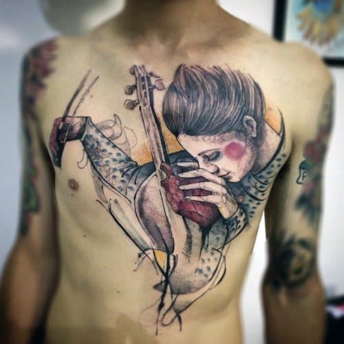 Artistic chest tattoo of a woman playing a violin, blending sketch-style lines with soft color accents for a dreamy, expressive composition.