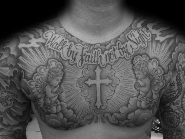 Chest tattoo featuring a bold cross, two praying cherubs, and the phrase Walk by Faith Not by Sight in elegant script with radiant shading.