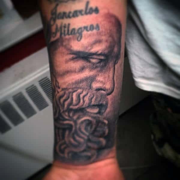 Forearm tattoo of an ancient bearded man with text above that reads "Generales Milagros"